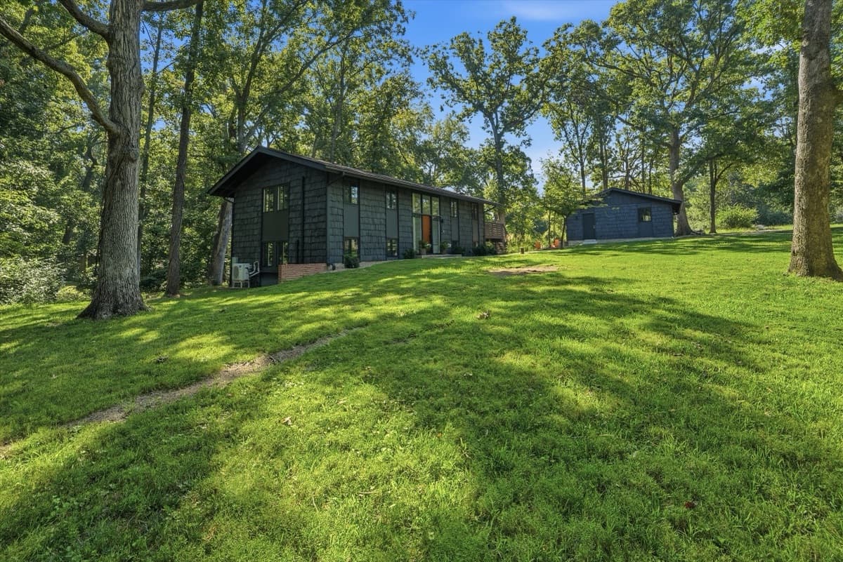 Side lawn with the house and detached garage under mature oaks