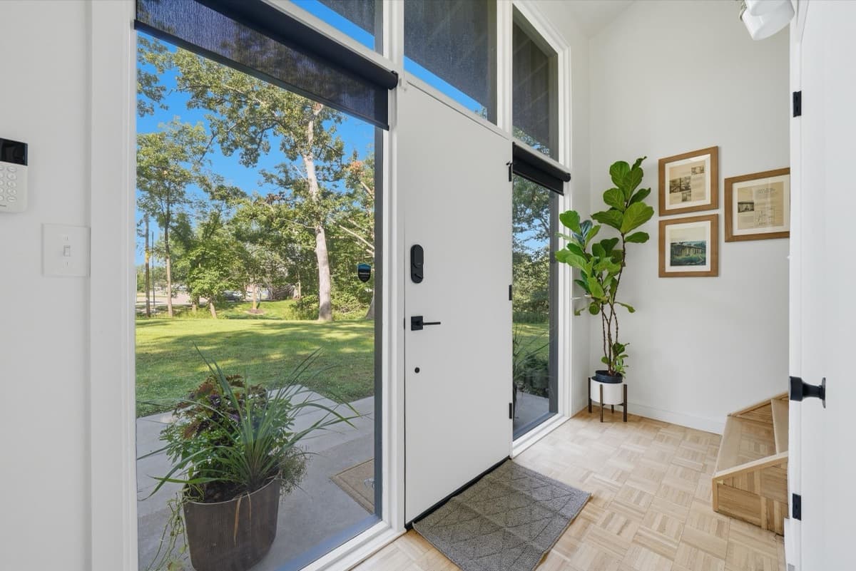 Entry foyer with glass sidelights and parquet flooring