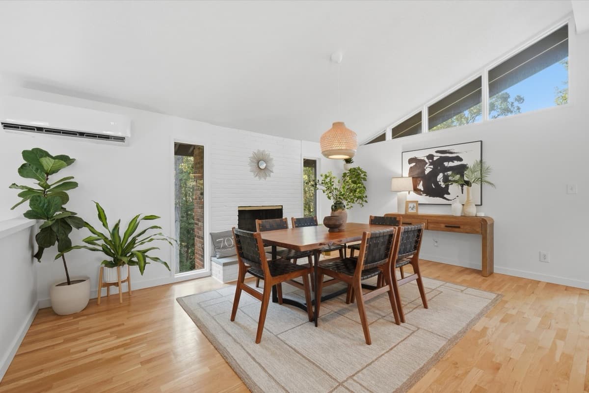 Dining room with vaulted ceiling and brick fireplace
